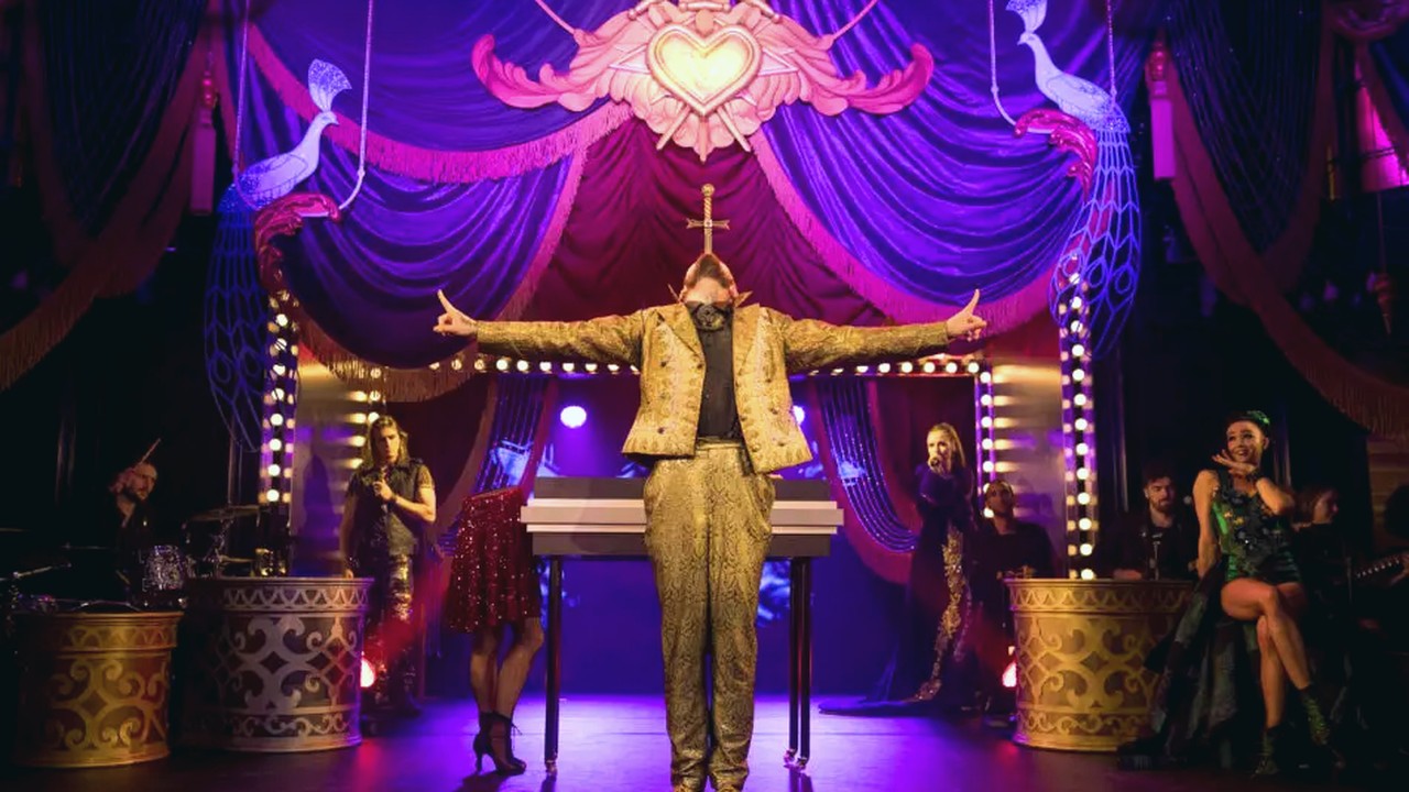 Live theatre performance with video playback and lighting integration
